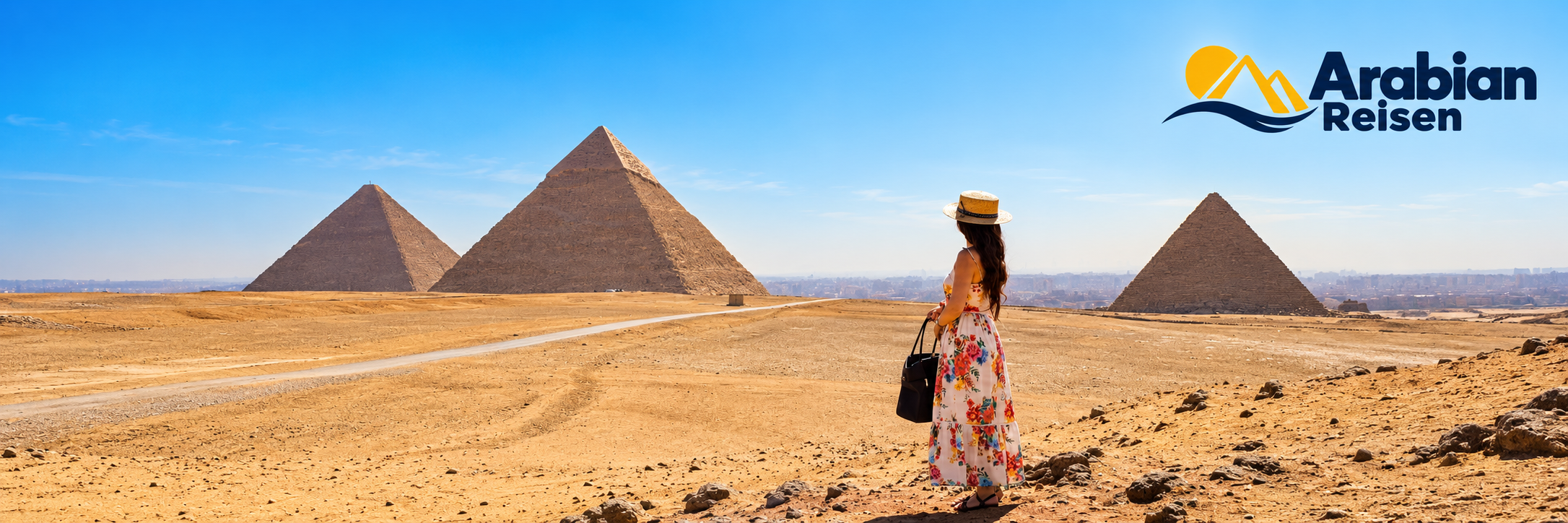 Traveller overlooking the Pyramids of Giza with the Arabian Reisen logo